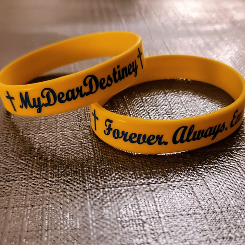 Yellow wristband with blue writing - MyDearDestiney Foundation